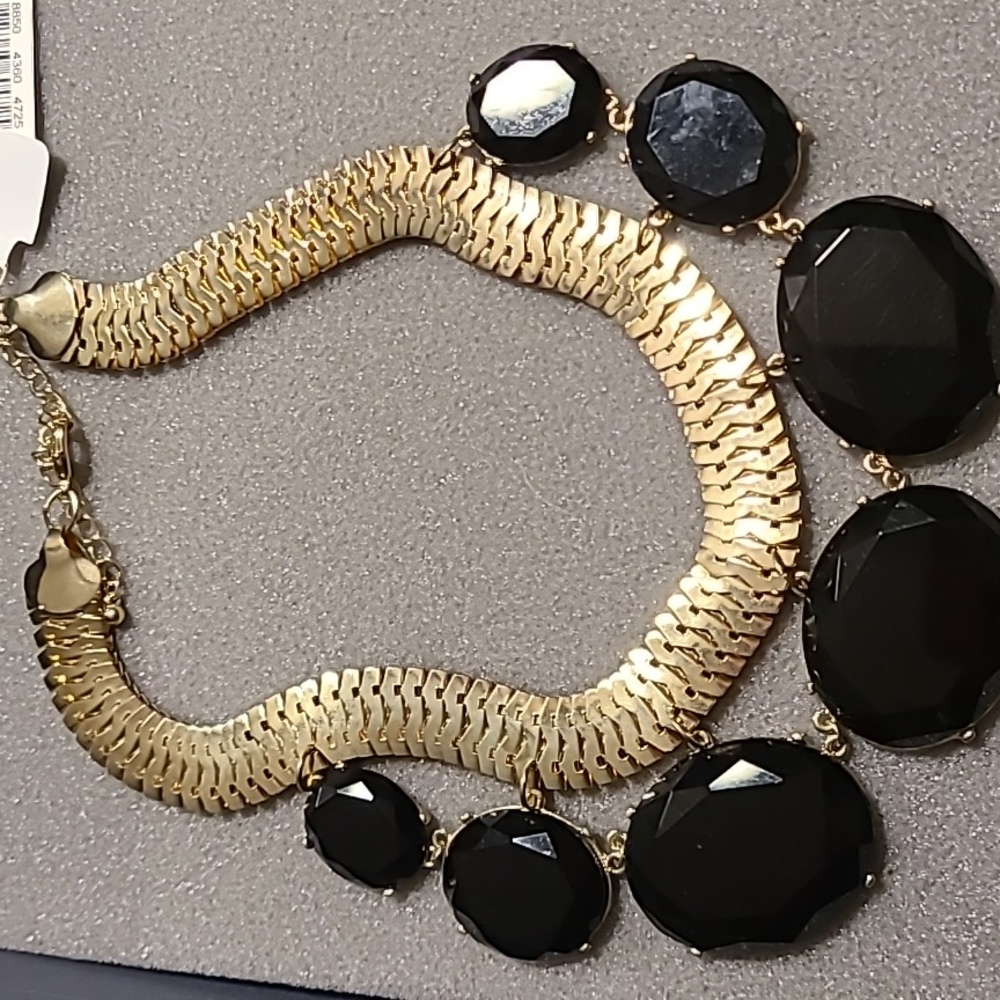 Brand New Gold Tone Fashion Necklace with 7 Black circles with a Lobster Clasp